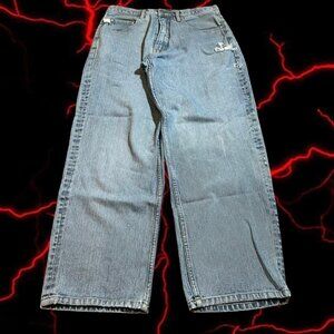 Distressed light wash denim jeans with a baggy fit and ripped details